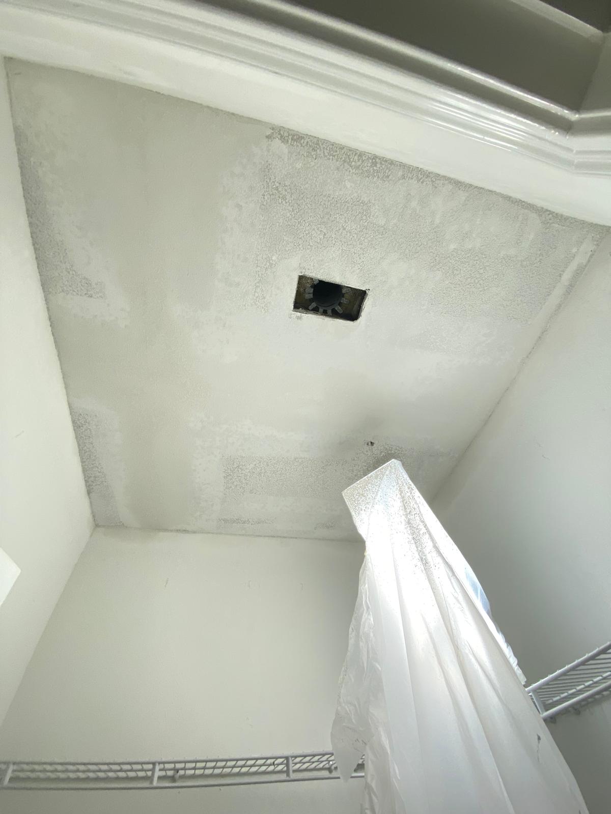 Closet with textured ceiling drywall finish