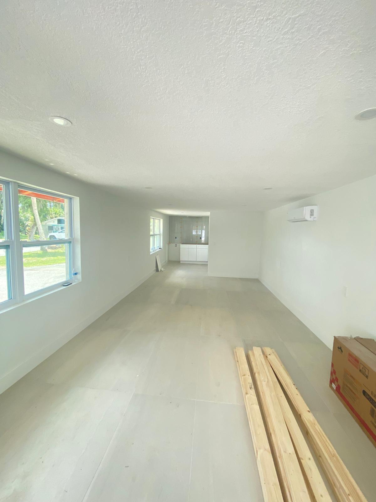 Open floor plan with white wall painting