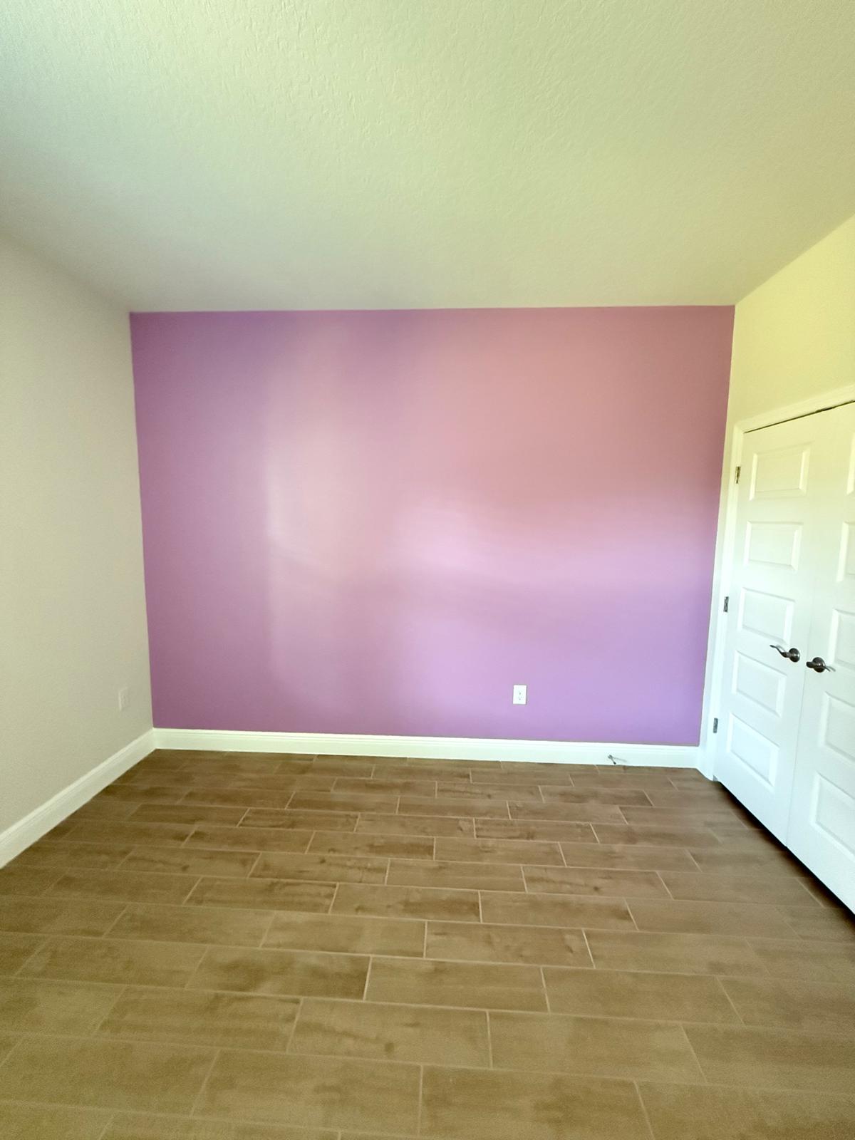 Bedroom with purple accent wall
