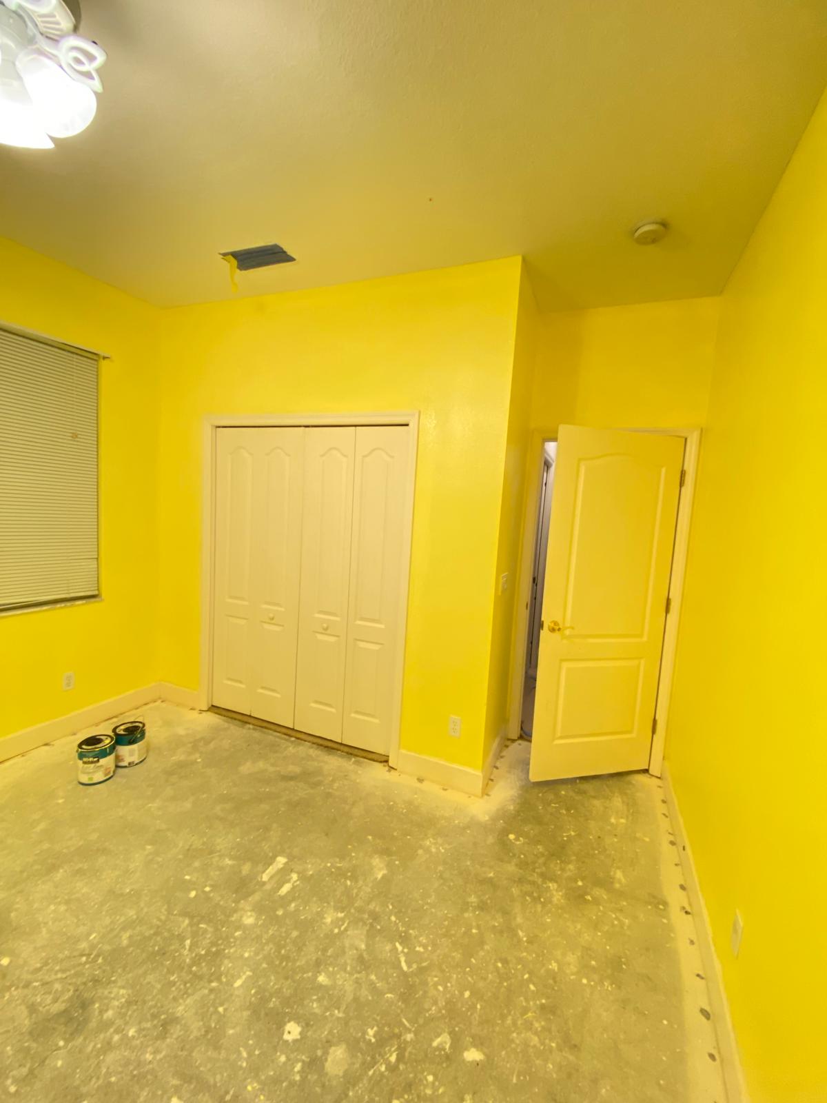 Bedroom with bright yellow and closet