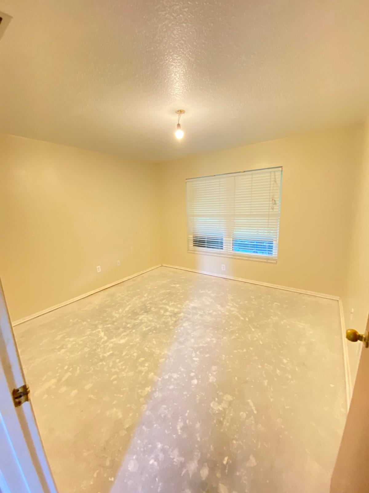 Empty bedroom with light cream walls